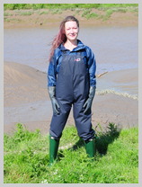  Wearing Flex-o-thane dungarees into the mudbanks featuring Lucia, The Office Manager 