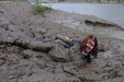 view details of set gm-4m051, Miss Abigail takes a spectacular mudbath in a tight fitting coated denim jumpsuit